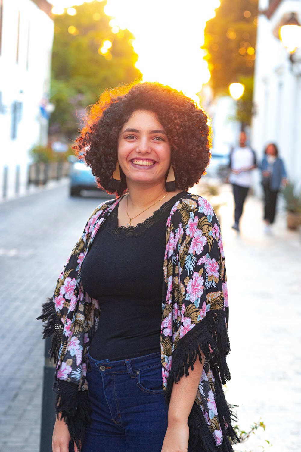 woman in black shirt with yellow and pink floral scarf