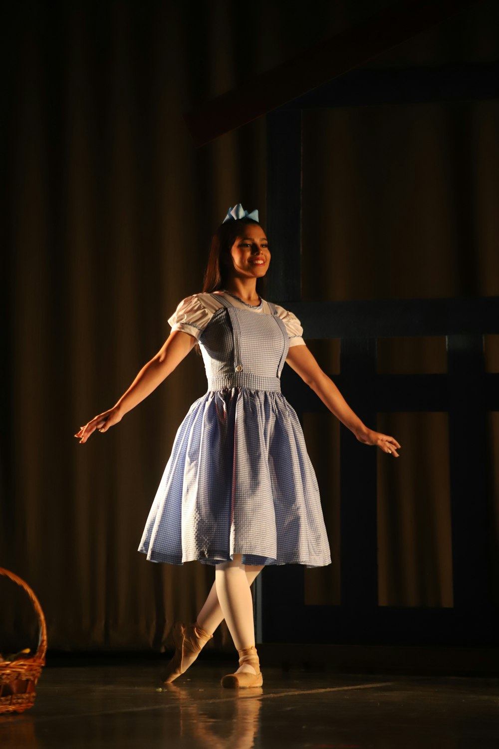 woman in white and blue dress standing on stage
