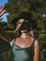 A model wearing layered necklaces in an outdoor setting.