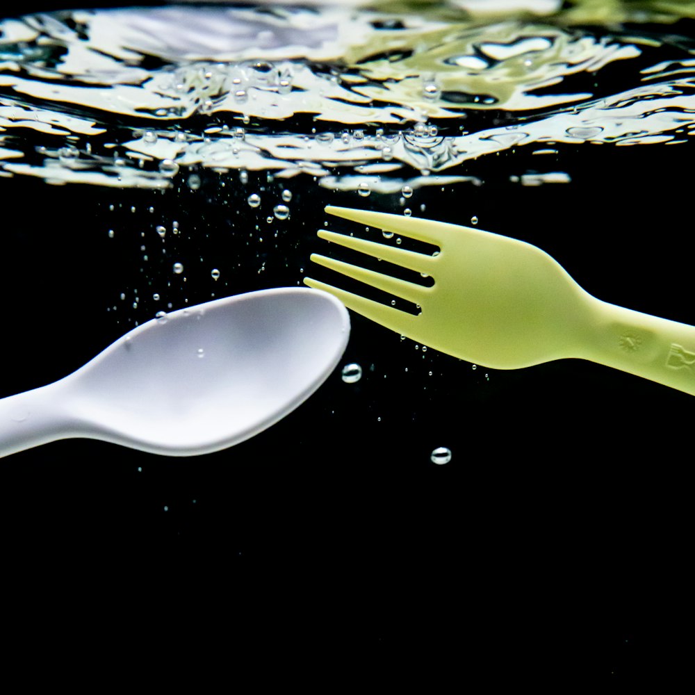 white plastic spoon on water
