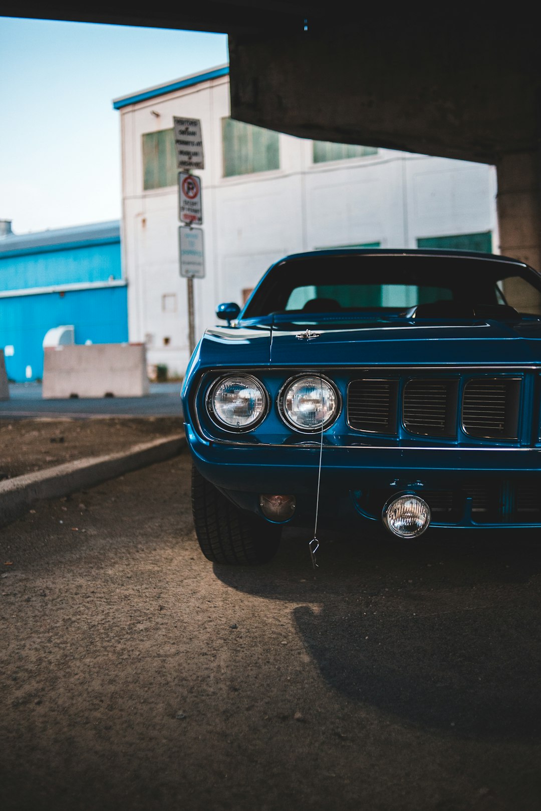 blue car parked near building during daytime