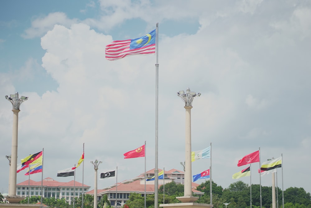 flags on poles under cloudy sky during daytime