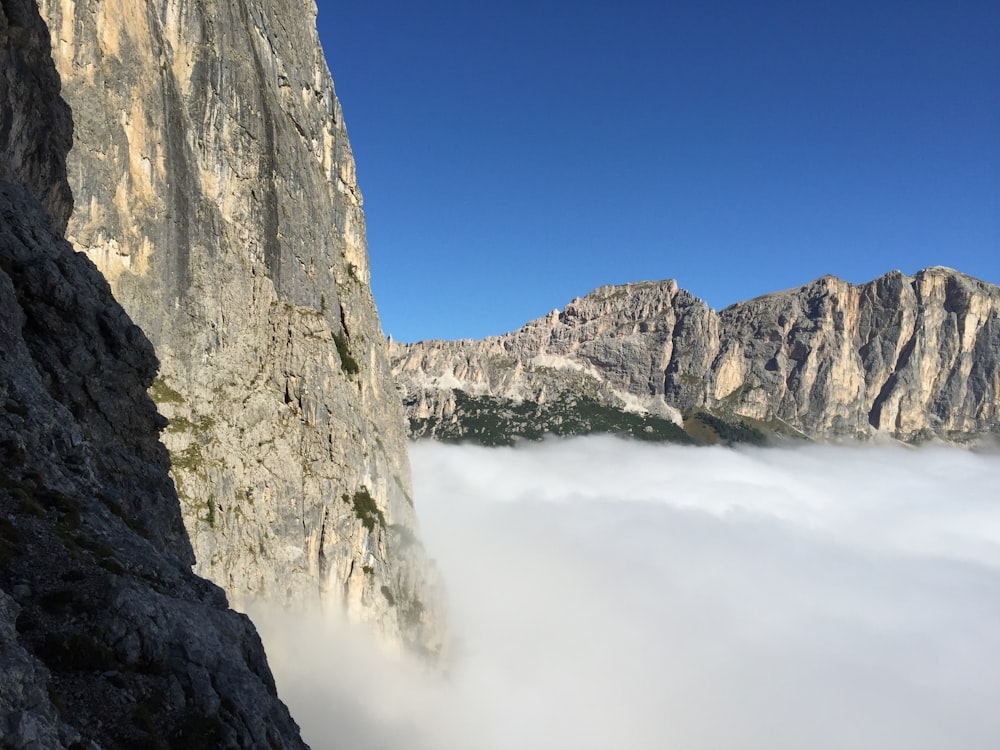 rocky mountain with clouds during daytime