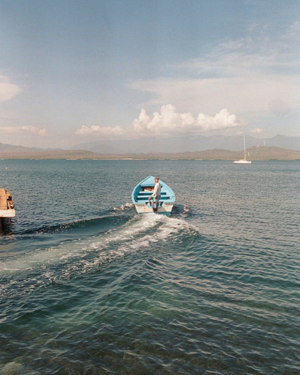 a man on a boat in the middle of the ocean