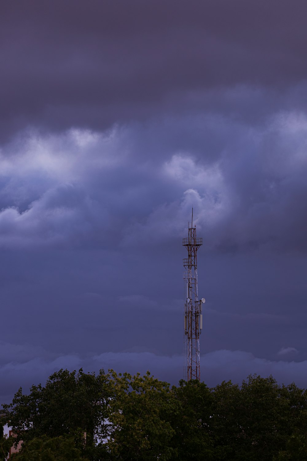 white and black tower under white clouds