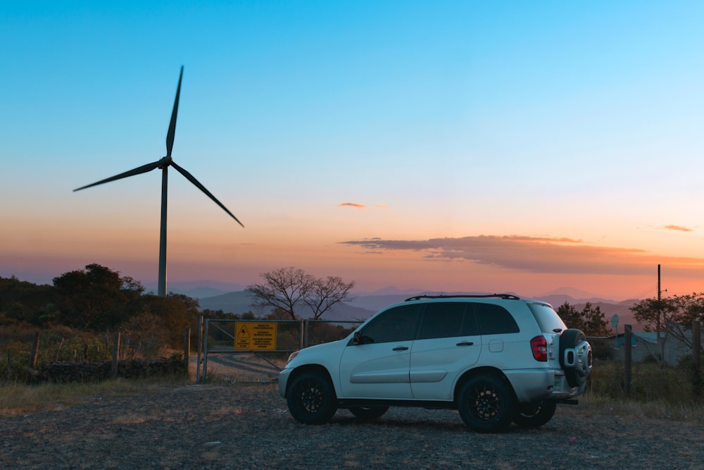 white crew cab pickup truck on road during sunset