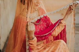 woman in red and gold sari dress