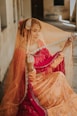 woman in red and gold sari dress