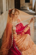 woman in red and gold sari dress