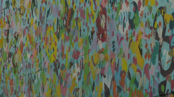 A vibrant mural blending abstract shapes and faces, symbolizing creative collaboration.