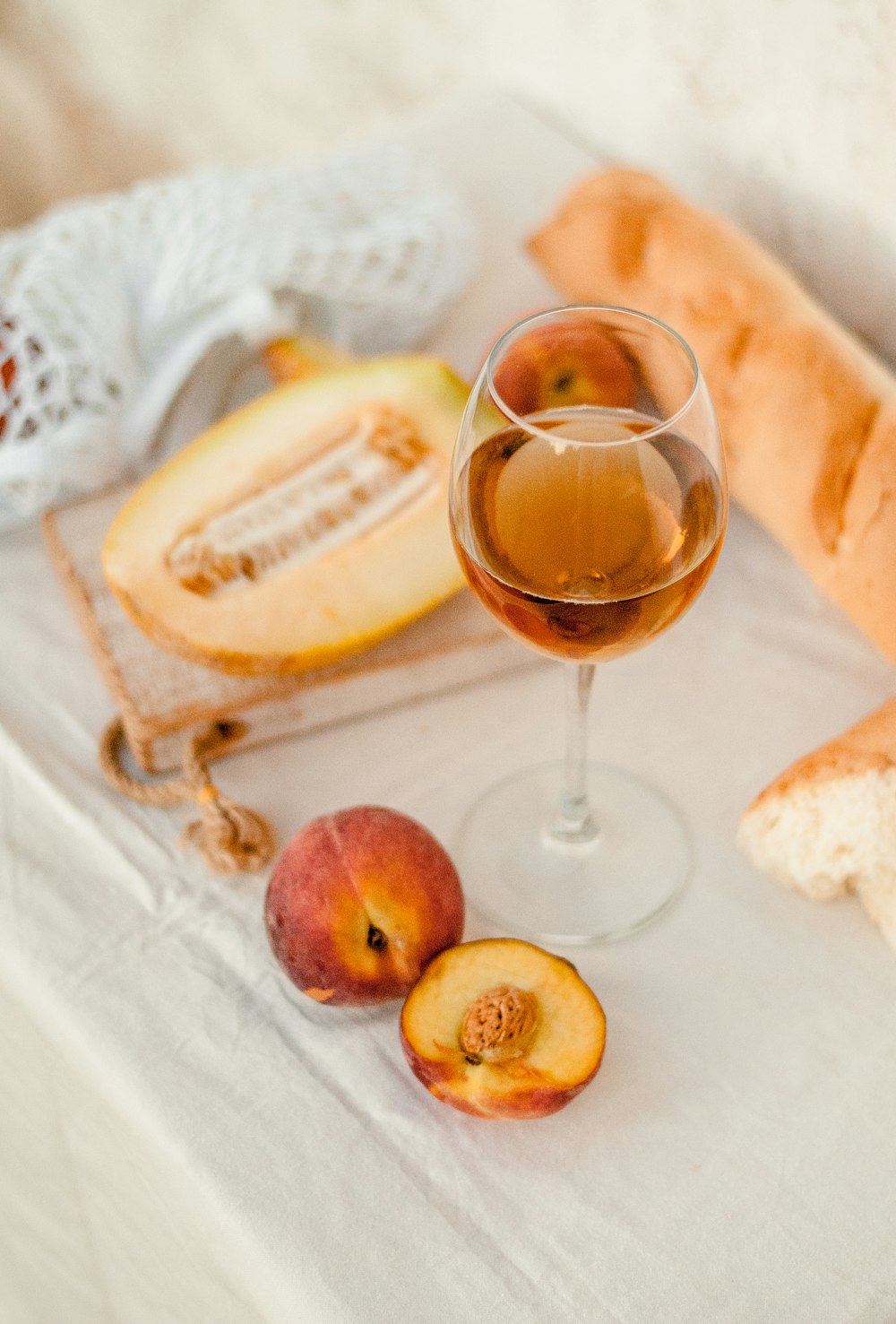 a glass of wine and some bread on a table