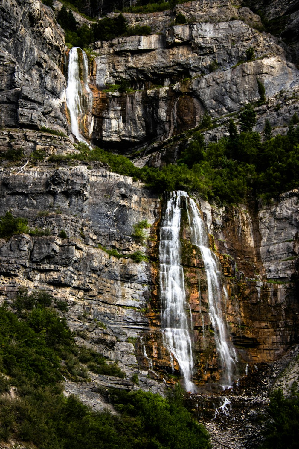 waterfalls on rocky mountain during daytime