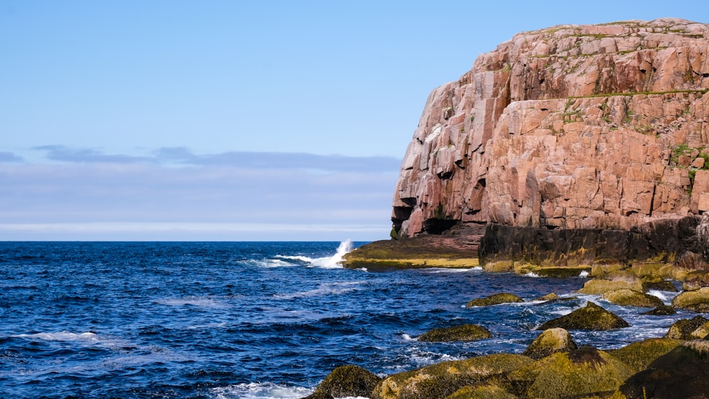 brown rock formation on sea during daytime