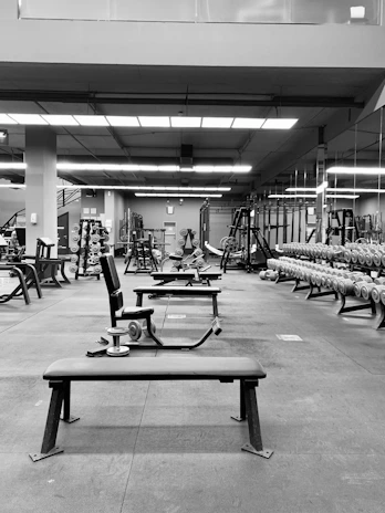 Wide shot of a fitness center with rubber roll flooring absorbing impact from weight training.