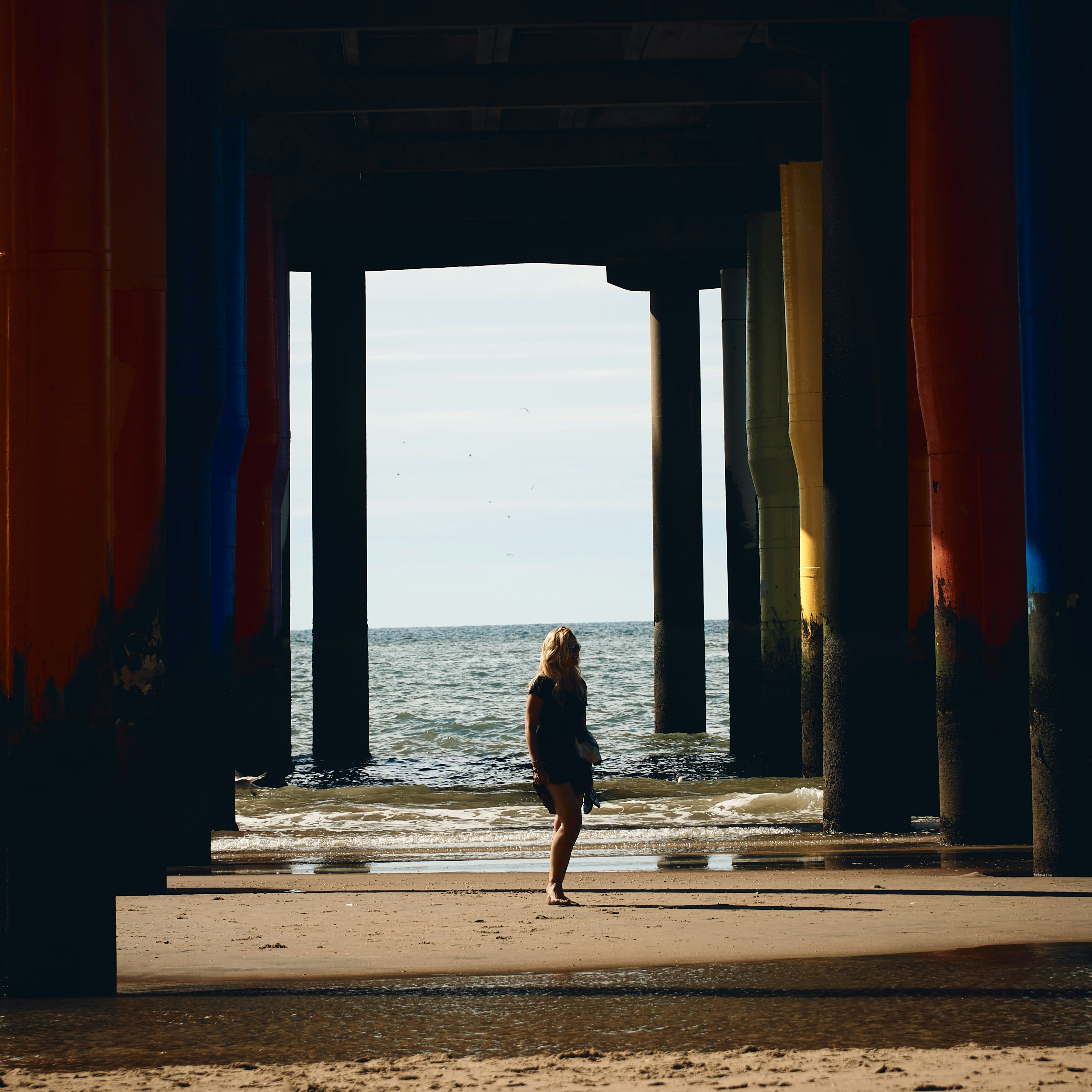 woman in black dress walking on hallway