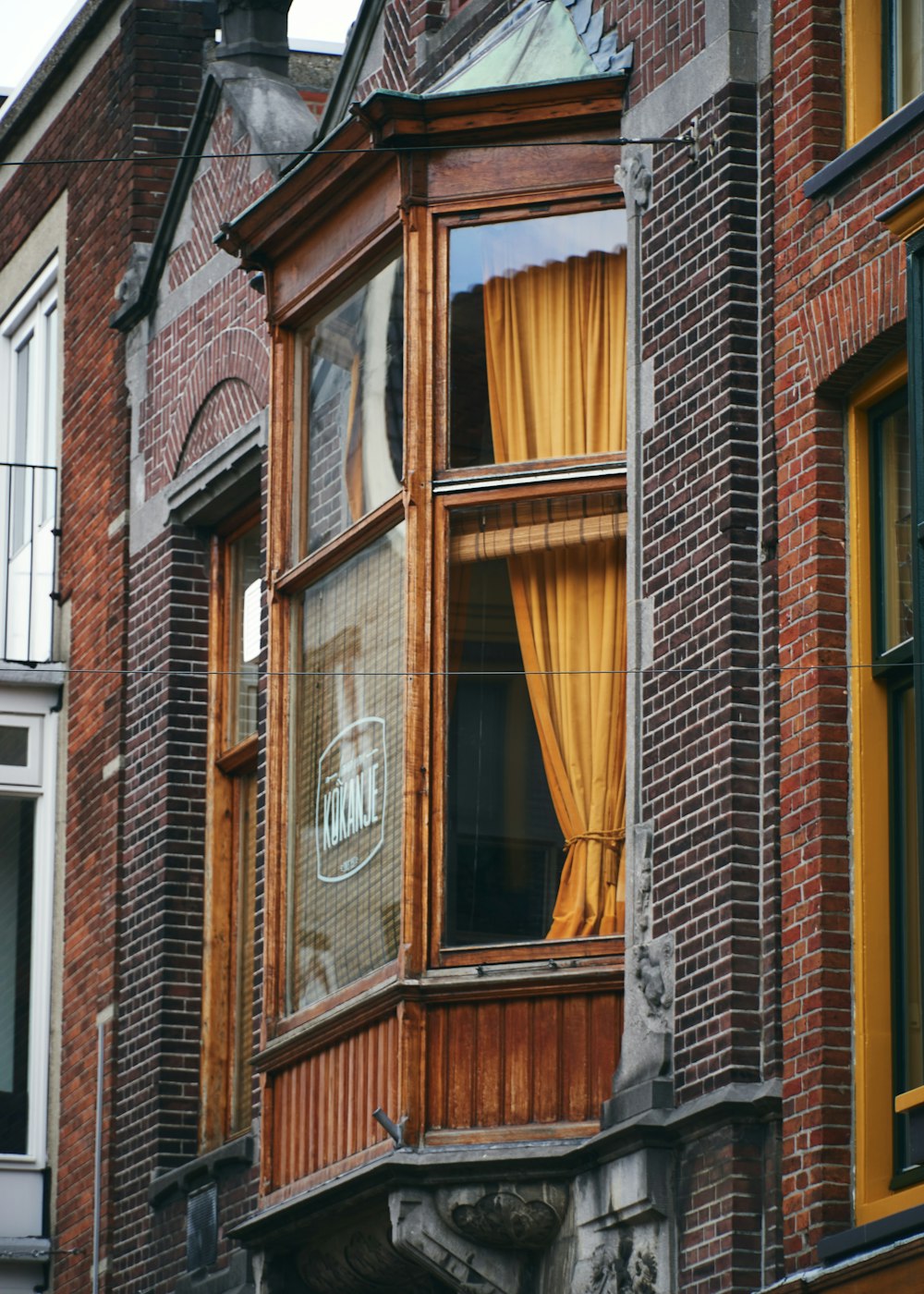 brown wooden framed glass window