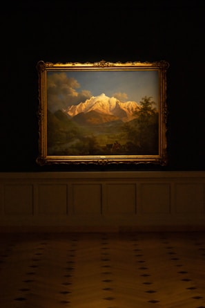 A beautifully framed landscape painting displayed on a wall.