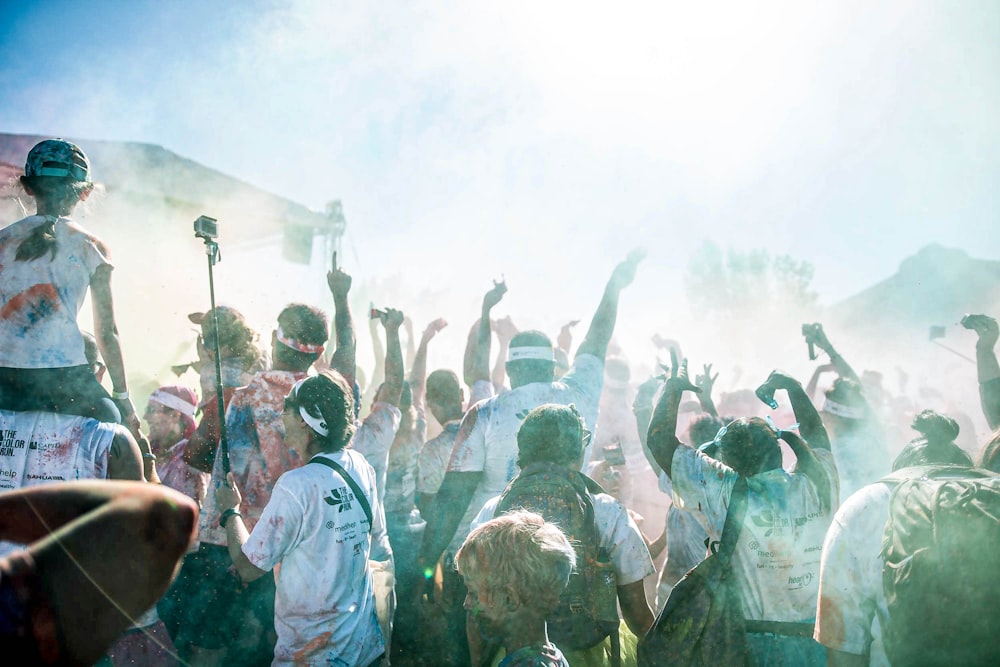 people raising their hands during daytime