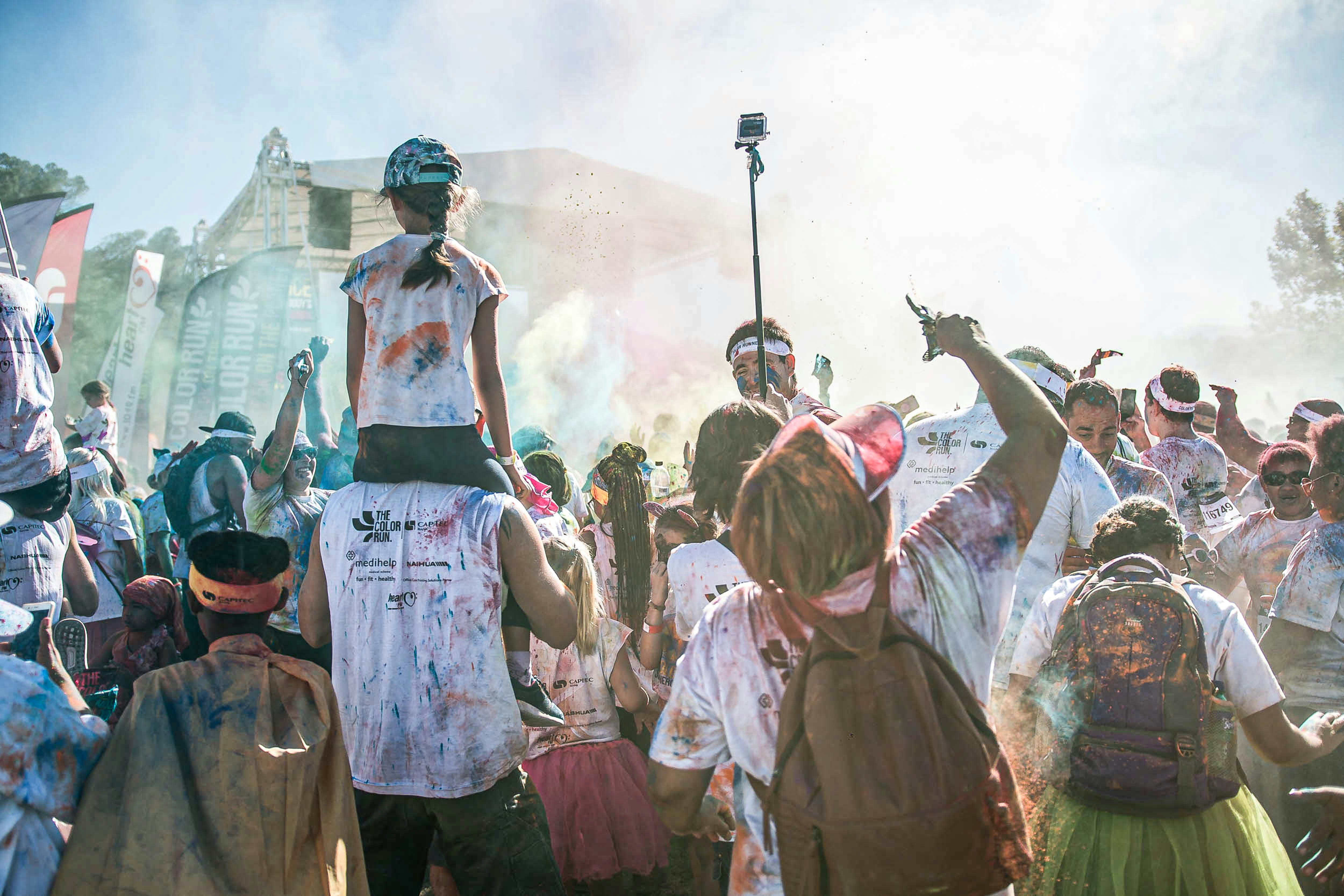 people standing on field with smoke during daytime