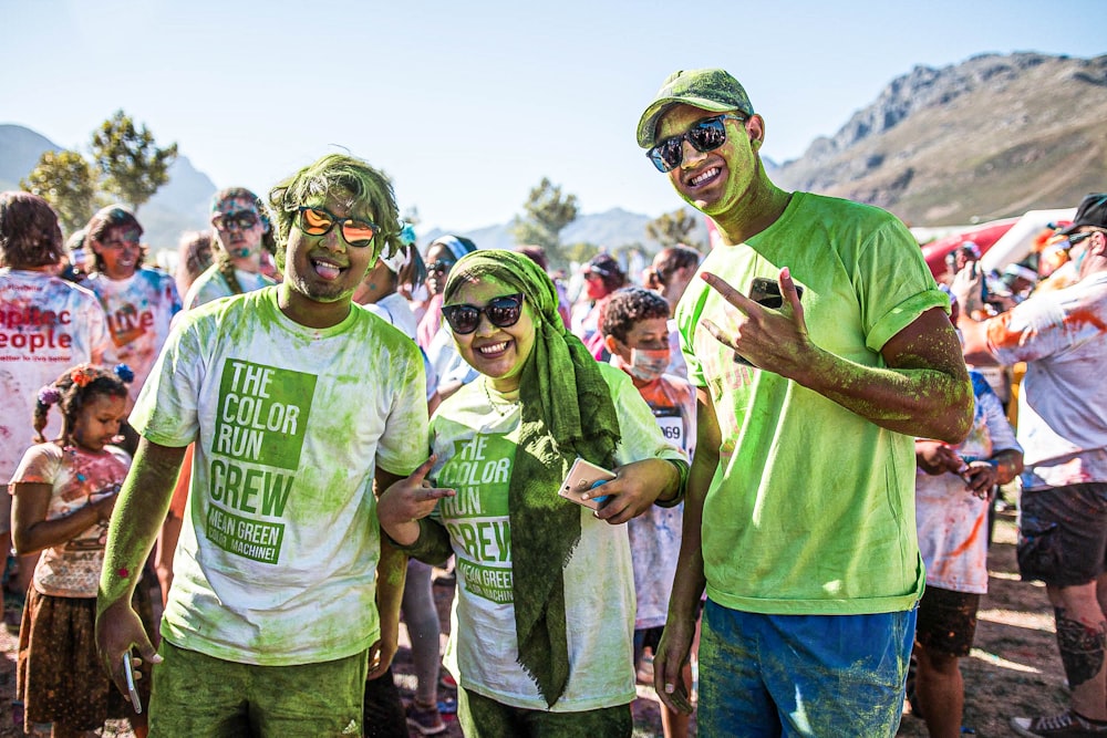 group of people wearing green crew neck t-shirts