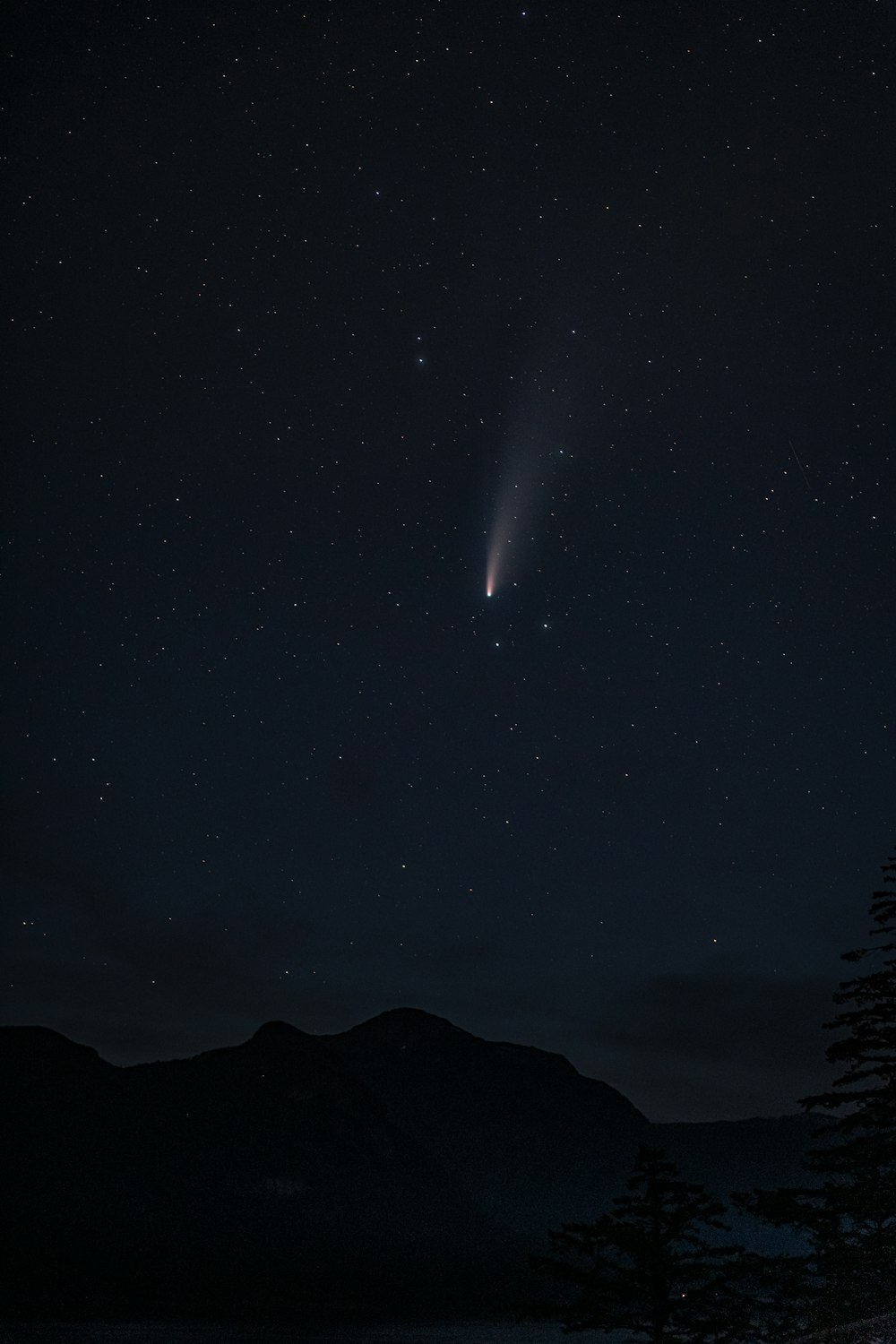 silhouette of mountain under starry night