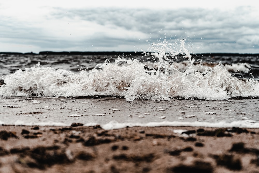 ocean waves on brown sand during daytime