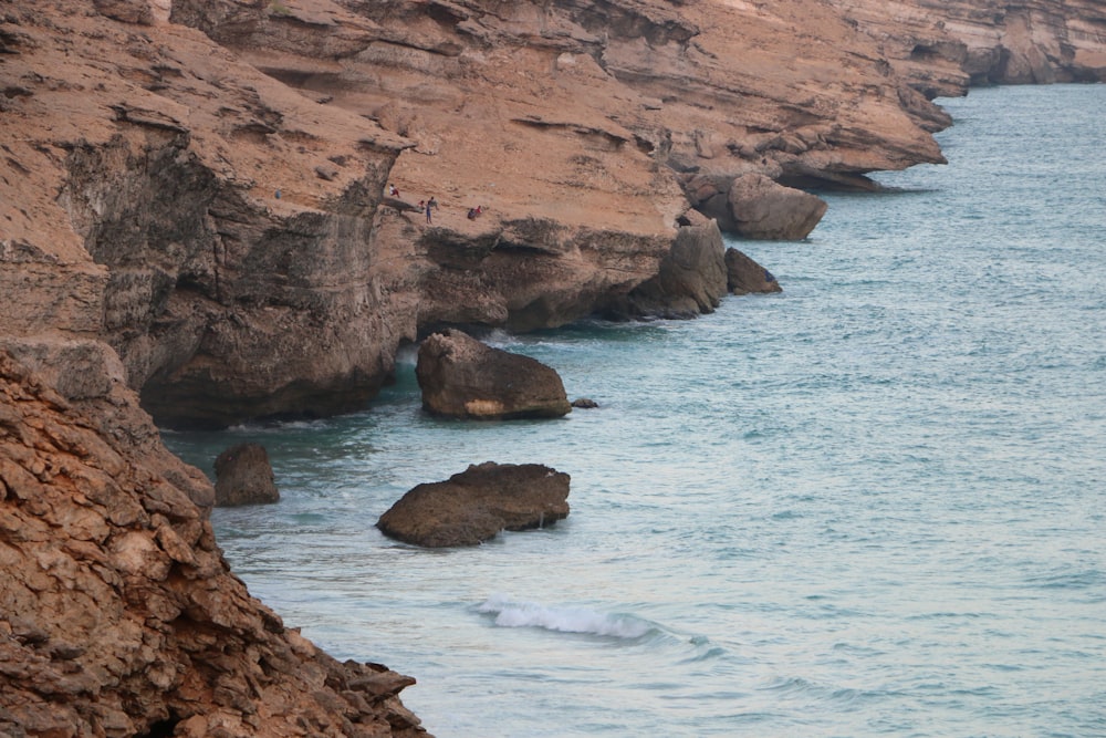 brown rock formation on sea during daytime