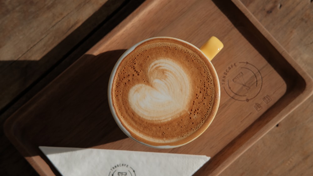 brown ceramic mug on brown wooden table