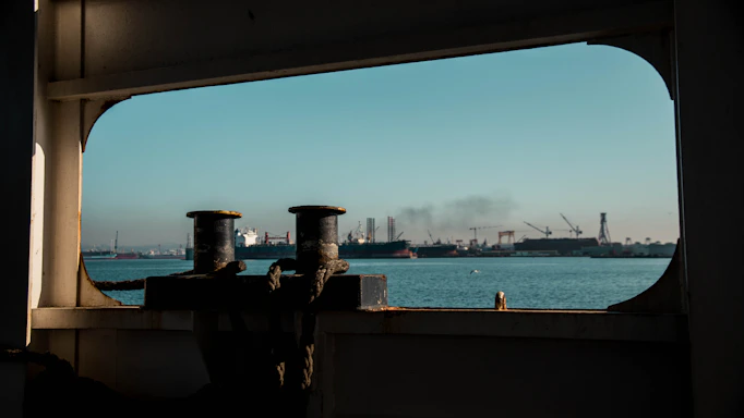 A friendly marine supply office at Port Said with ships visible through large windows.