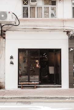 A sleek air curtain installed above a busy store entrance, gently blowing air downward.