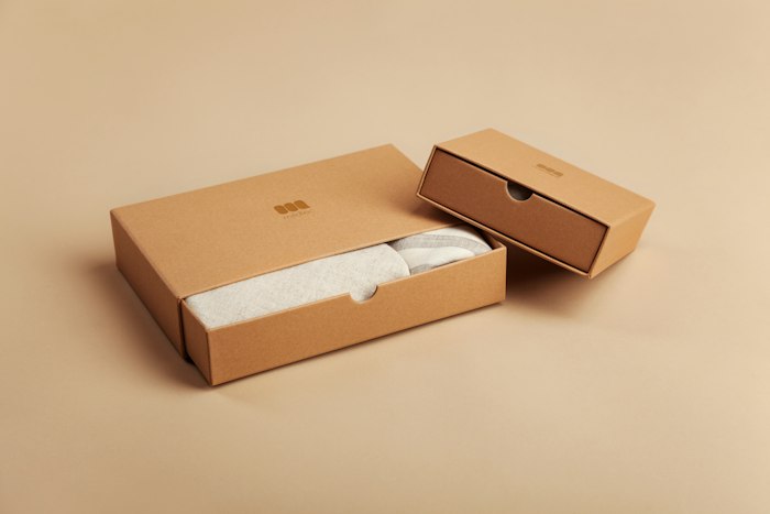 Kraft product boxes on a beige background