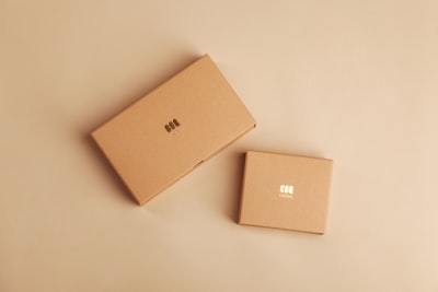 brown cardboard box on white table package google meet background