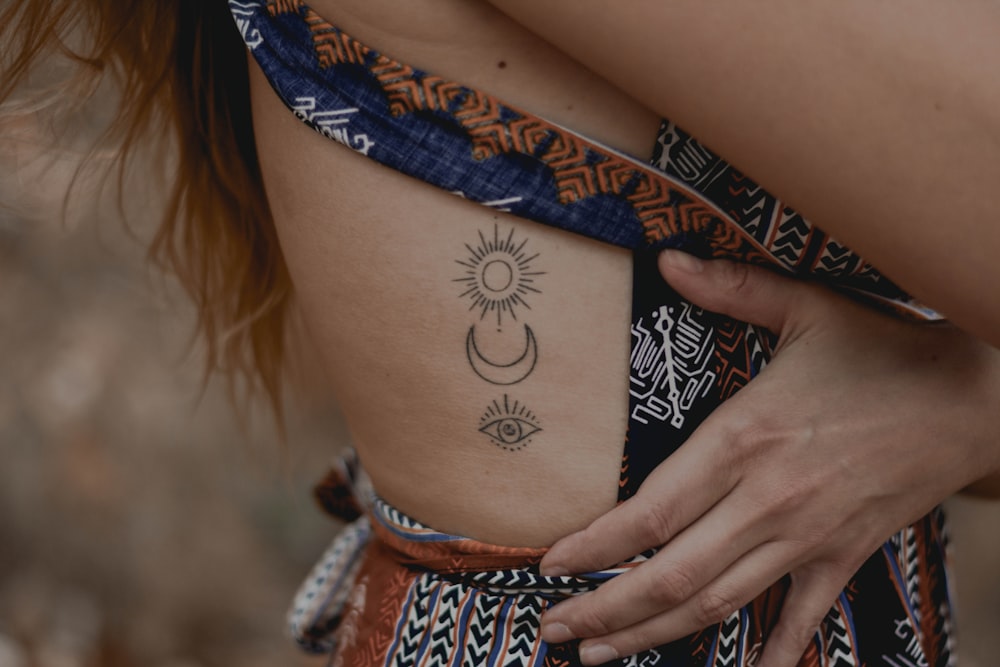 woman with floral tattoo on her right arm