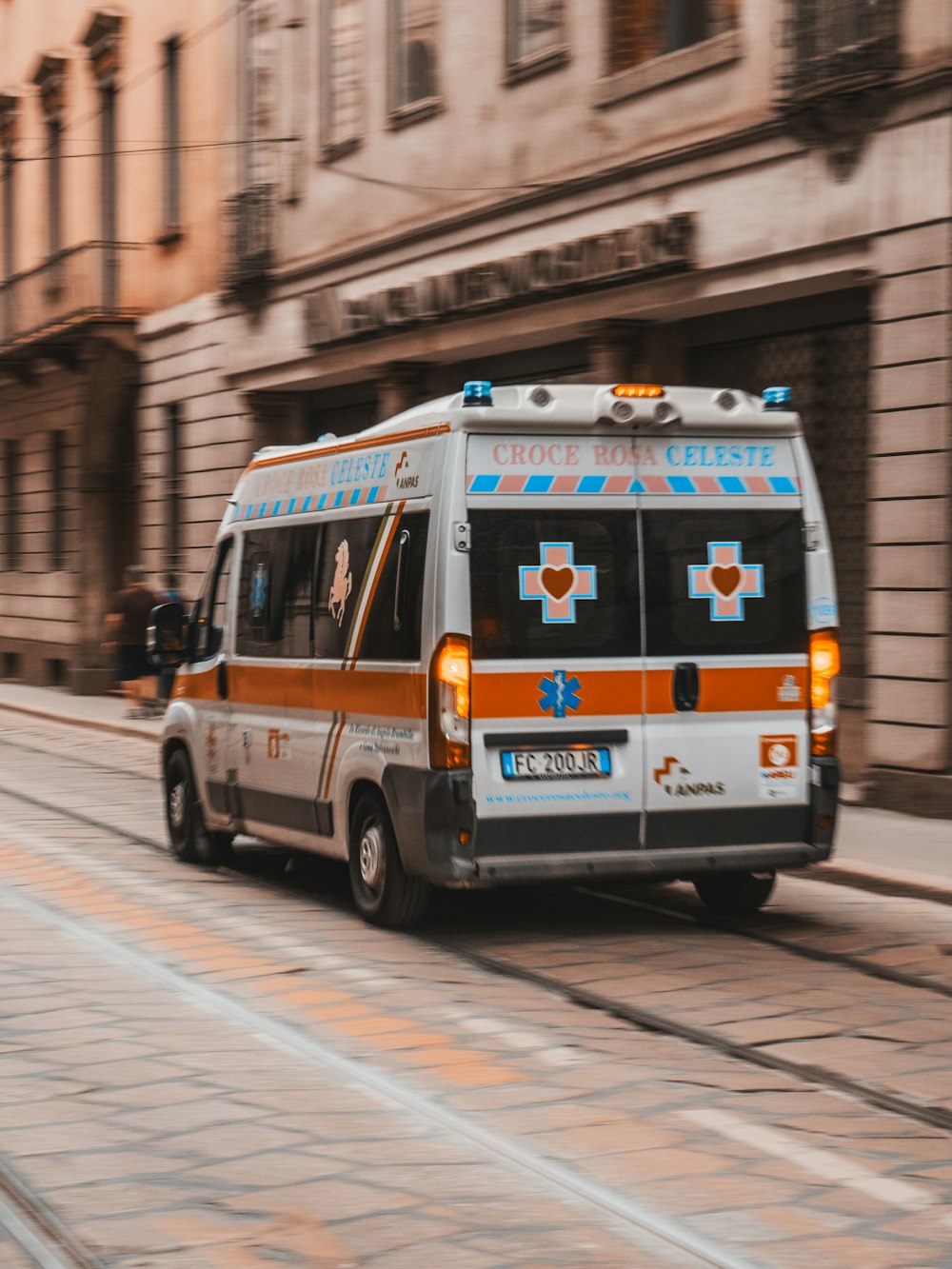 white and orange van parked near building during daytime