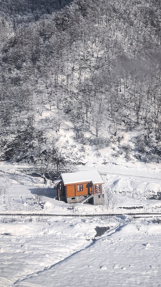 brown and white house on snow covered ground in Tufandag Azerbaijan