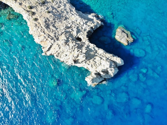 aerial view of gray and black rock formation on blue sea during daytime in Gavdos Greece