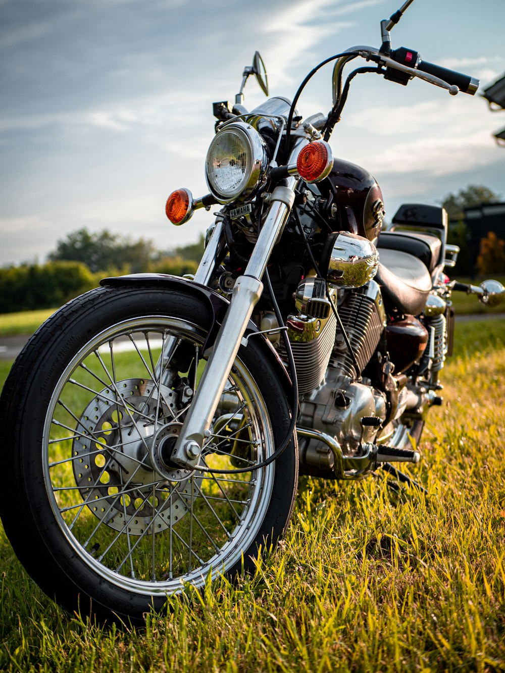 black and silver cruiser motorcycle on green grass field during daytime