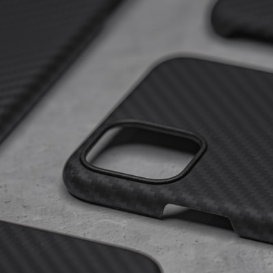Close-up of a sleek silicone iPhone case in matte black on a white background