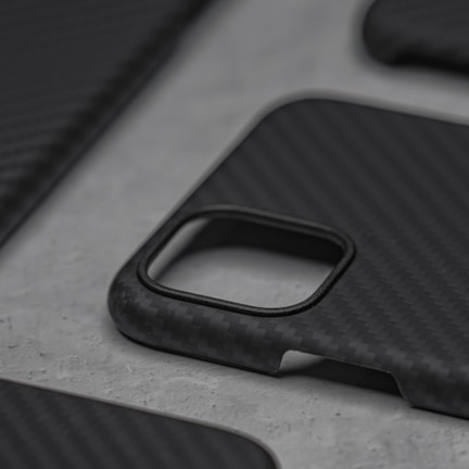 Close-up of a sleek iPhone 17 Pro upgrade case in titanium finish on a minimalist black background.