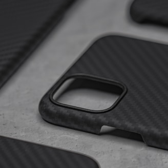 Close-up of a sleek phone case with a pixelated composite texture on a black background