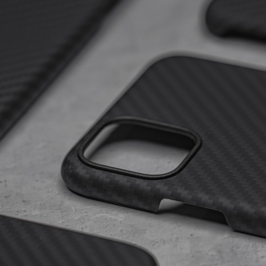 Close-up of a sleek black iPhone case with a subtle matte finish on a white background