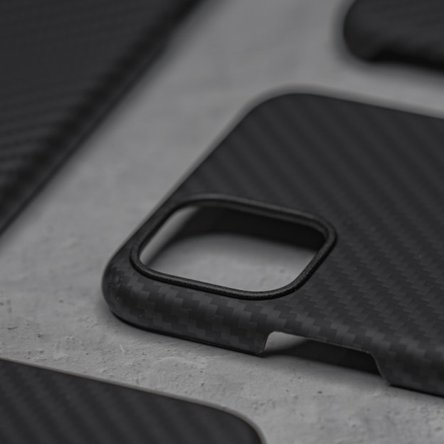 Close-up of a sleek phone case with a pixelated composite texture on a black background
