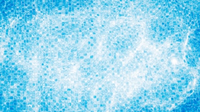 Overhead view of a pool with intricate geometric mosaic patterns.