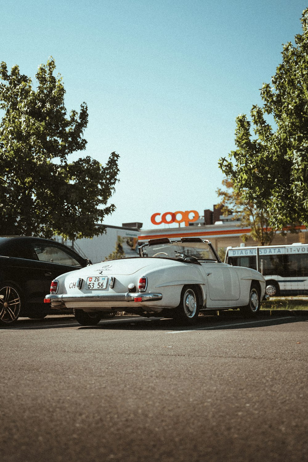 white porsche 911 parked on road during daytime