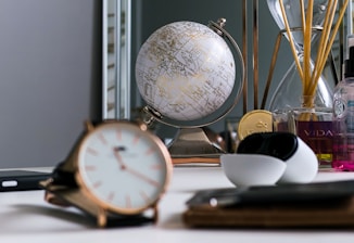 Luxurious workspace featuring gold accents, green plants, and fragrance samples.