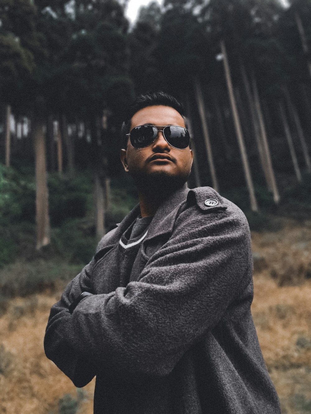 man in gray hoodie wearing black sunglasses