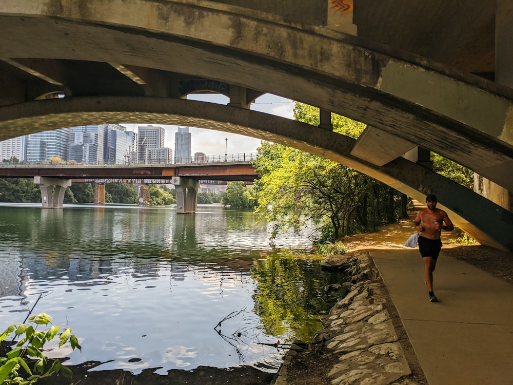 people walking on bridge over river during daytime