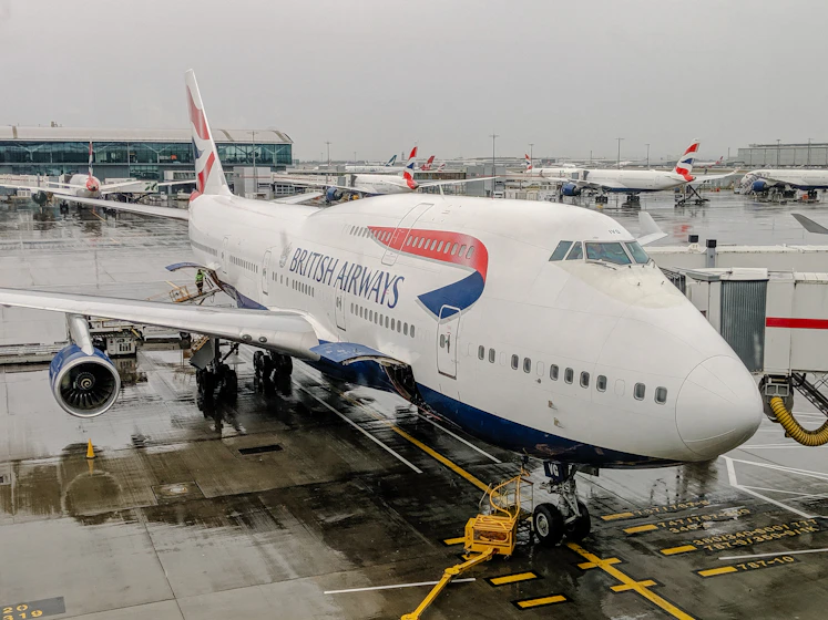 white and blue airplane on airport during daytime