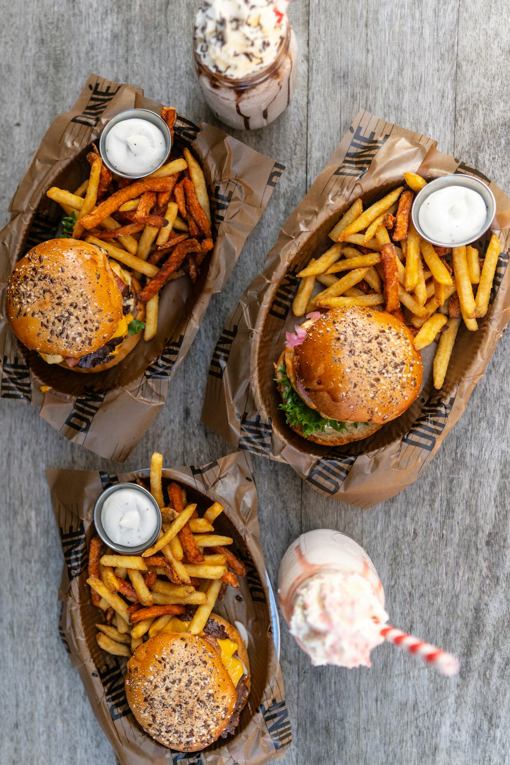 burger and fries on brown paper plate