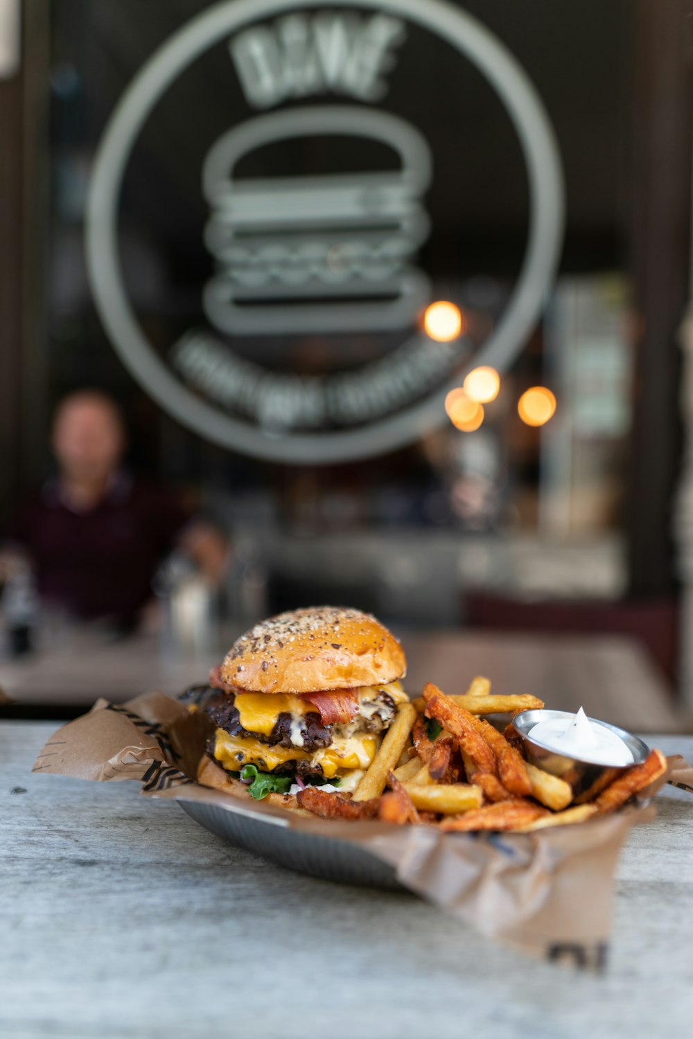 burger with fries on brown wooden table